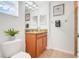 Well-lit half bathroom featuring granite countertops and tiled floors at 3193 Pequod Pl, Kissimmee, FL 34746