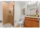 Bathroom featuring a tiled shower with glass door, sink with granite counters, and modern fixtures at 3193 Pequod Pl, Kissimmee, FL 34746