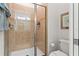 Tiled bathroom featuring a glass-enclosed shower and a modern toilet for convenience at 3193 Pequod Pl, Kissimmee, FL 34746