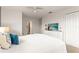 Bright bedroom with white walls, ceiling fan, and a TV atop a dresser with a comfy bed at 3193 Pequod Pl, Kissimmee, FL 34746