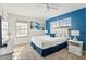 Bright and airy bedroom featuring a cozy bed with blue accents, ample natural light, and a calming atmosphere at 3193 Pequod Pl, Kissimmee, FL 34746