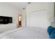 Comfortable bedroom showcasing a closet and a dresser with a television at 3193 Pequod Pl, Kissimmee, FL 34746