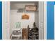 Storage closet with various items, including stroller, high chair, and overhead shelving at 3193 Pequod Pl, Kissimmee, FL 34746