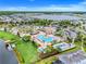 Aerial shot of the community pool area, featuring a splash pad, seating, and lush landscaping at 3193 Pequod Pl, Kissimmee, FL 34746