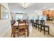 Open dining area with hardwood table set, bar seating at countertop, and modern appliances at 3193 Pequod Pl, Kissimmee, FL 34746