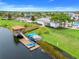Aerial view of a lake with a dock, pavilion, and kayak storage in a picturesque community at 3193 Pequod Pl, Kissimmee, FL 34746