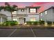 Inviting townhouse showcasing manicured bushes and a palm tree in front, offering a serene living environment at 3193 Pequod Pl, Kissimmee, FL 34746