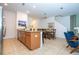 Modern kitchen featuring an island with granite countertops, stainless steel appliances, and a view of the dining area at 3193 Pequod Pl, Kissimmee, FL 34746