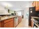 Spacious kitchen with stainless steel appliances, wood cabinets, and an eat-in bar area at 3193 Pequod Pl, Kissimmee, FL 34746
