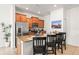 Modern kitchen with stainless steel appliances, granite countertops, breakfast bar, and ample cabinet space at 3193 Pequod Pl, Kissimmee, FL 34746