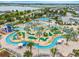 Overhead view of a lazy river and miniature golf course in a tropical community at 3193 Pequod Pl, Kissimmee, FL 34746