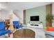 Bright living area with staircase, light green accent wall, wooden features, and an open design at 3193 Pequod Pl, Kissimmee, FL 34746