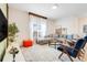 Stylish living room with hardwood accents, blue seating, and ample natural light at 3193 Pequod Pl, Kissimmee, FL 34746