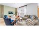 Comfortable living room with a stylish sofa, accent chairs, modern decor, and a bright window for natural light at 3193 Pequod Pl, Kissimmee, FL 34746