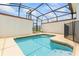 In-ground pool surrounded by screened enclosure, with views of the backyard and neighborhood at 3193 Pequod Pl, Kissimmee, FL 34746