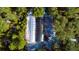 Aerial view of greenhouse structures nestled in a wooded area at 32645 Red Oak Dr, Eustis, FL 32736