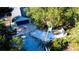 Expansive home with garage and outdoor dining space surrounded by lush greenery at 32645 Red Oak Dr, Eustis, FL 32736