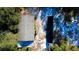 Aerial view of a home featuring solar panels in a wooded area at 32645 Red Oak Dr, Eustis, FL 32736