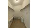 Spacious walk-in closet with shelving units and tiled floors at 32645 Red Oak Dr, Eustis, FL 32736