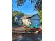 Charming home exterior with a well-manicured yard, two chairs and a blue pot near the garage at 32645 Red Oak Dr, Eustis, FL 32736