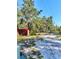 Exterior view of property with shed, trees and driveway at 32645 Red Oak Dr, Eustis, FL 32736