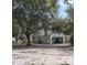 Charming single-story home featuring an attached garage, mature trees and a spacious, sandy front yard at 32645 Red Oak Dr, Eustis, FL 32736