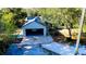 Home exterior featuring an attached garage, concrete driveway, and wooded surroundings at 32645 Red Oak Dr, Eustis, FL 32736
