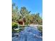 Exterior view of property with shed, trees and driveway at 32645 Red Oak Dr, Eustis, FL 32736