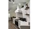 Modern kitchen with white cabinets, stainless steel appliances, and stylish white range hood at 32645 Red Oak Dr, Eustis, FL 32736