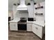 Charming kitchen showcasing white cabinetry, stainless appliances and sleek countertops at 32645 Red Oak Dr, Eustis, FL 32736