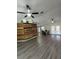 Spacious living room featuring wood style flooring, accent wall and ceiling fan at 32645 Red Oak Dr, Eustis, FL 32736