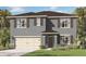 Two-story home featuring a two-car garage, shutters, and a well-manicured lawn at 33604 Seattle Slew Dr, Sorrento, FL 32776