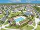 Beautiful aerial view of a neighborhood pool and lounge area surrounded by palms and lush landscaping at 3454 Somerset Park Dr # 36, Orlando, FL 32824