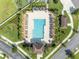 Aerial view of a community pool featuring lounge chairs, palm trees, and well-maintained landscaping at 3454 Somerset Park Dr # 36, Orlando, FL 32824