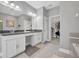 Bright bathroom featuring a double vanity with granite countertop and walk-in closet at 3454 Somerset Park Dr # 36, Orlando, FL 32824