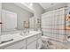 Bright bathroom featuring a single vanity and shower with a striped curtain at 3454 Somerset Park Dr # 36, Orlando, FL 32824