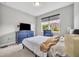 Cozy bedroom featuring a large window and blue dresser for ample storage at 3454 Somerset Park Dr # 36, Orlando, FL 32824