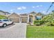 Beautiful single-Gathering home with a well-manicured lawn, three-car garage, and paved driveway on a sunny day at 3454 Somerset Park Dr # 36, Orlando, FL 32824