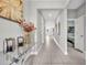 Bright hallway with neutral paint, tile floors, decorative console table, and artwork creating an inviting passage at 3454 Somerset Park Dr # 36, Orlando, FL 32824