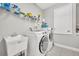 Functional laundry room with modern washer and dryer and utility sink at 3454 Somerset Park Dr # 36, Orlando, FL 32824