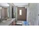 Tiled bathroom featuring a vanity with sink, a large mirror, and a shower at 4051 Crofford Ave, Haines City, FL 33844