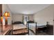 Bedroom featuring two twin beds, an accent lamp and a dark dresser at 4051 Crofford Ave, Haines City, FL 33844
