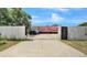 A charming house featuring a private driveway enclosed by white and black gates at 4051 Crofford Ave, Haines City, FL 33844