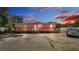 Exterior view of the home featuring a wooden deck, front lawn and parking area at 4051 Crofford Ave, Haines City, FL 33844