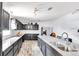 Bright kitchen featuring stainless steel appliances, granite countertops, and wood-look tile flooring at 4051 Crofford Ave, Haines City, FL 33844