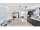 A modern kitchen featuring an island, granite countertops, and black cabinets at 4051 Crofford Ave, Haines City, FL 33844