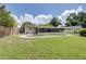 Fenced backyard featuring a lawn, landscaping and a swimming pool at 422 S Hawthorn Cir, Winter Springs, FL 32708