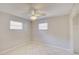 Neutral bedroom featuring tile flooring, a ceiling fan, and natural light from two windows at 422 S Hawthorn Cir, Winter Springs, FL 32708
