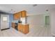 Bright kitchen with an island, wood cabinetry, and access to additional living space at 422 S Hawthorn Cir, Winter Springs, FL 32708