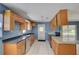 Well-lit kitchen with stainless steel appliances, dark countertops, and ample cabinet space at 422 S Hawthorn Cir, Winter Springs, FL 32708